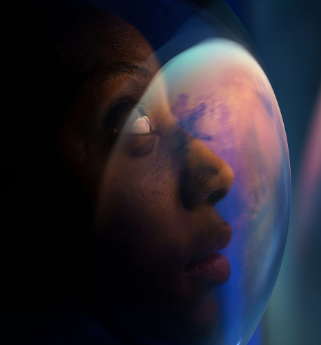 Person looking out of a convex window into outer space